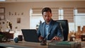 Smiling businessman answering call at laptop table workplace. Happy boss talking Royalty Free Stock Photo