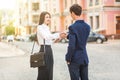 Smiling businessman and businesswomen handshake for a business meeting outdoor.