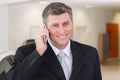 Smiling businessman calling with his mobile phone