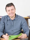 Smiling businessman casual sit at office table desk