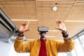 Smiling businessman in casuals using virtual reality headset in creative office Royalty Free Stock Photo