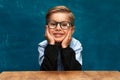 Smiling businessman child sitting at the table Royalty Free Stock Photo