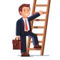 Smiling businessman climbing up the career ladder Royalty Free Stock Photo