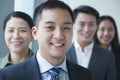 Smiling Businessman with co-workers in office portrait