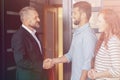 Businessman congratulating happy couple buying flat Royalty Free Stock Photo