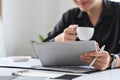 Businessman drinking coffee and reading news on digital tablet. Royalty Free Stock Photo