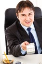 Smiling businessman giving dollar pack