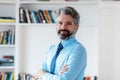 Smiling businessman with grey hair and necktie