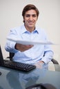 Smiling businessman handing over paperwork