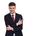 Smiling businessman with hands crossed pointing to side Royalty Free Stock Photo