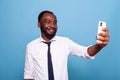 Smiling businessman having fun taking a selfie photo using smat phone front camera Royalty Free Stock Photo