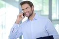 Smiling businessman having phone call - Successful businessman - blue shirt