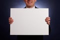 Smiling businessman holding a big blank card Royalty Free Stock Photo