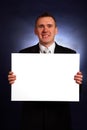 Smiling businessman holding a big blank card Royalty Free Stock Photo