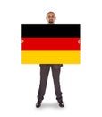 Smiling businessman holding a big card, flag of Germany Royalty Free Stock Photo
