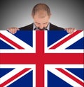 Smiling businessman holding a big card, flag of the United Kingdom Royalty Free Stock Photo