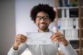 Smiling Businessman Holding Cheque Royalty Free Stock Photo