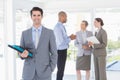 Smiling businessman holding files and looking at camera Royalty Free Stock Photo