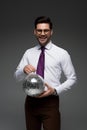 Smiling businessman holding glass disco ball Royalty Free Stock Photo