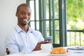 Smiling businessman holding mobile phone in restaurant Royalty Free Stock Photo