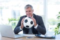 Smiling businessman holding soccer ball Royalty Free Stock Photo