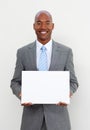 Smiling businessman holding white card Royalty Free Stock Photo