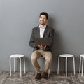 smiling businessman with laptop waiting