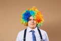 Smiling businessman with large colorful wig Royalty Free Stock Photo