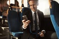Smiling businessman listening to music on his morning commute Royalty Free Stock Photo
