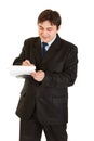 Smiling businessman making notes in document Royalty Free Stock Photo