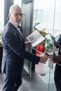 Businessman with newspaper and paper cup Royalty Free Stock Photo