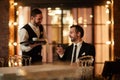 Smiling Businessman ordering Coffee in Restaurant Royalty Free Stock Photo