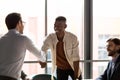 Smiling businessman praising mixed race employee at office. Royalty Free Stock Photo