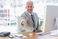 Smiling businessman reaching out arm for handshake Royalty Free Stock Photo