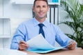Smiling businessman reading a contrat before signing it Royalty Free Stock Photo