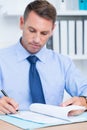 Smiling businessman reading a contrat before signing it Royalty Free Stock Photo