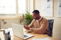 Smiling Businessman Relaxing Office. Positive Guy Holding Smartphone At Table Royalty Free Stock Photo