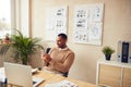 Smiling Businessman Relaxing Office. Positive Guy Holding Smartphone At Table Royalty Free Stock Photo