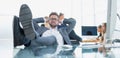 smiling businessman relaxing sitting at the office Desk Royalty Free Stock Photo