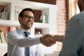 Smiling businessman shake hand of business client at meeting Royalty Free Stock Photo