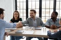 Smiling businessmen handshake closing deal at meeting Royalty Free Stock Photo