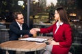 Smiling businessman shaking hands with his business partner