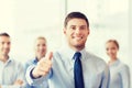 Smiling businessman showing thumbs up in office Royalty Free Stock Photo
