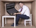 Smiling businessman shows empty briefcase, laughs at his own naivety Royalty Free Stock Photo