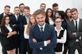 Smiling businessman standing on background of her business team. Royalty Free Stock Photo