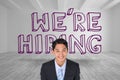 Smiling businessman standing in front of were hiring graphic