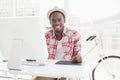 Smiling businessman in straw hat using digitizer