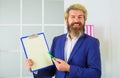 Smiling businessman in suit with blank clipboard and pen. Office worker with folder. Planning. Copy space. Royalty Free Stock Photo