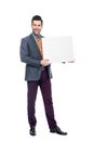 smiling businessman in suit holding blank placard, Royalty Free Stock Photo