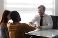 Smiling businessman in suit shaking hands with african american man. Royalty Free Stock Photo